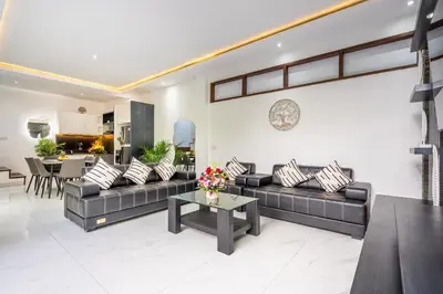 a living room with a couch and a table at Villa Shinta by JB Villas in Seminyak