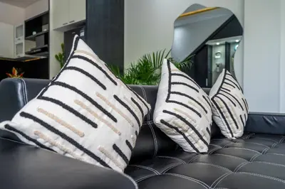three black and white pillows on a couch at Villa Shinta by JB Villas in Seminyak