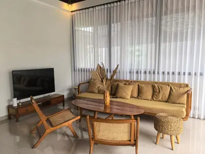 a living room with a couch and a table at Villa Veyla Seminyak 10 mins walk to beach in Seminyak