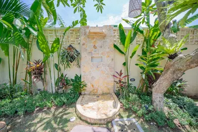 a garden with a stone fountain in front of a building at Luxury Balinese Oasis with private pool - 2 BR in Kerobokan