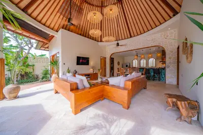 an open living room with a couch and a table at Luxury Balinese Oasis with private pool - 2 BR in Kerobokan