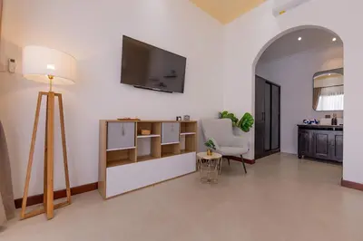 a living room with a television on the wall at Villa Fénix Brand New 1BR Villa in Umalas, Bali in Kerobokan