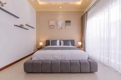 a bedroom with a large bed with a large window at Villa Fénix Brand New 1BR Villa in Umalas, Bali in Kerobokan