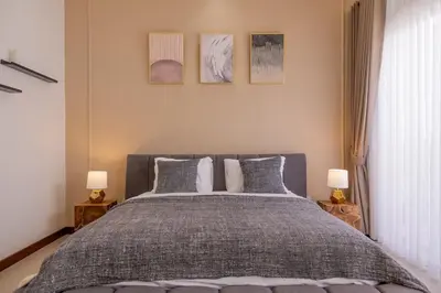 a bedroom with a large bed with two lamps at Villa Fénix Brand New 1BR Villa in Umalas, Bali in Kerobokan