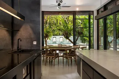 a kitchen with a table and a dining room at Walk, Best of Berawa, 5bd villa, 2min from Finns in Canggu