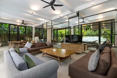 a large living room with couches and a television at Walk, Best of Berawa, 5bd villa, 2min from Finns in Canggu