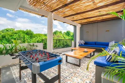 a patio with a table and a giant chessboard at Jimbaran Breeze Villa By Island Escape in Jimbaran