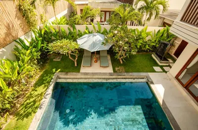 an overhead view of a swimming pool with an umbrella at NEW! 3BR HnRR Villa Near Seminyak in Kerobokan