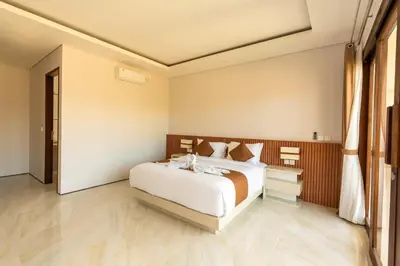 a bedroom with a large bed in a room at NEW! 3BR HnRR Villa Near Seminyak in Kerobokan