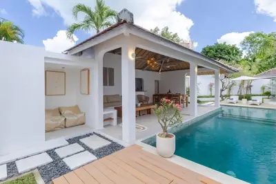 a villa with a swimming pool and a house at Villa Cocodrilos 1 by Pertama Management in Seminyak
