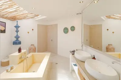 a white bathroom with two sinks and a tub and a tubermott at Villa Cocodrilos 1 by Pertama Management in Seminyak