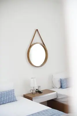 a bedroom with two beds and a mirror on the wall at The Cendana Villa Umalas in Badung