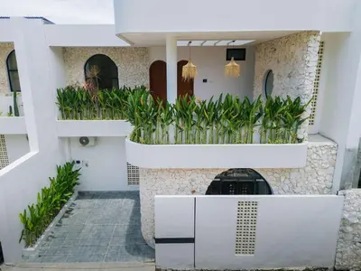 a house with plants on the balconies at The Coral Villa 3 BR Brand New Villa in Umalas in Kerobokan