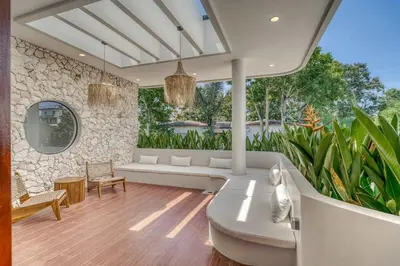 a living room with a white couch and some plants at The Coral Villa 3 BR Brand New Villa in Umalas in Kerobokan