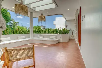 a living room with a couch and a large window at The Coral Villa 3 BR Brand New Villa in Umalas in Kerobokan