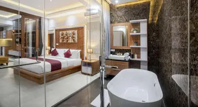 a bathroom with a bed and a shower and a tub at Puri Sahadewa Seminyak in Seminyak