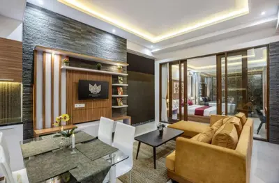 a living room with a couch and a table at Puri Sahadewa Seminyak in Seminyak