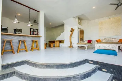 a large living room with a table and a fireplace at Villa Langit Ocean View Jimbaran in Jimbaran