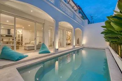 a large swimming pool in a house at Brand New 4BR Colonial Retreat in Berawa, Canggu in Canggu