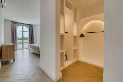 an empty hallway with a room with a window at Brand New 4BR Colonial Retreat in Berawa, Canggu in Canggu