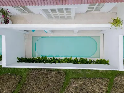 a large window on the side of a house at Brand New 4BR Colonial Retreat in Berawa, Canggu in Canggu
