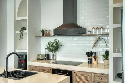 a kitchen with a sink and a stove at Brand New 4BR Colonial Retreat in Berawa, Canggu in Canggu