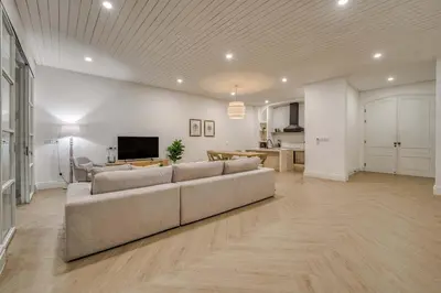 a large living room with a couch and a tv at Brand New 4BR Colonial Retreat in Berawa, Canggu in Canggu