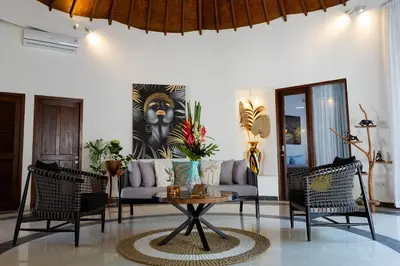 a living room with a couch and chairs and a table at Peaceful 2br with pool & garden in Seminyak