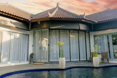a house with a swimming pool in front of it at Peaceful 2br with pool & garden in Seminyak