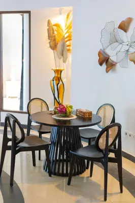 a dining room table with chairs and a vase at Peaceful 2br with pool & garden in Seminyak