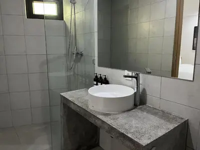 a bathroom with a sink and a shower at Teras by Tamora in Badung