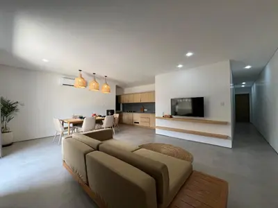 a living room with a couch and a dining room at Teras by Tamora in Badung