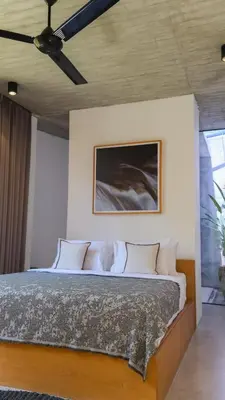 a bedroom with a bed with a ceiling fan at Teras by Tamora in Badung