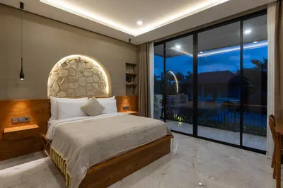 a bedroom with a bed and a large window at Sandat Villa 123 in Canggu
