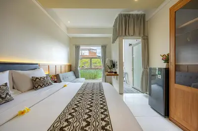 a bedroom with a large bed in a room at Bali True Living in Denpasar
