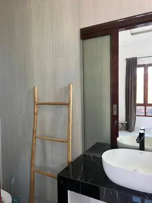 a bathroom with a sink and a mirror at Modern 3BR Villa with Private Pool & Rooftop in Nusa Dua in Nusa Dua