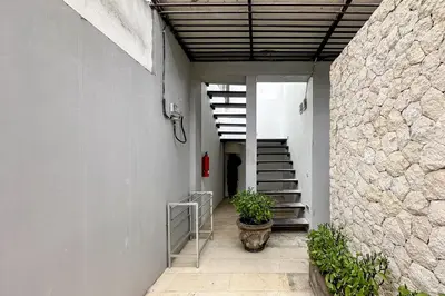 a hallway of a building with stairs and a plant at Green Leaf Villa - 1 Bedroom pool Villa with Minimum Stay 2 Nights in Nusa Dua