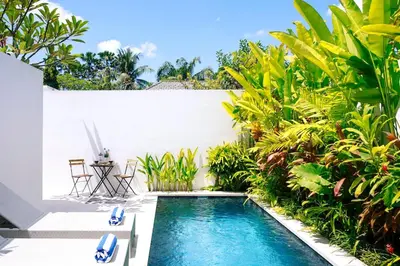 a pool in the backyard of a house with plants at Abby May - Top location near Potato Head, walk everywhere! in Seminyak