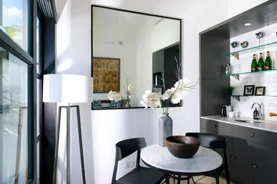a kitchen with a table and chairs and a sink at Abby May - Top location near Potato Head, walk everywhere! in Seminyak