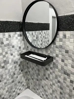 a bathroom with a mirror and a sink at D nux House in Ngurah Rai International Airport