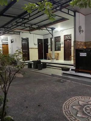 a building with a lot of doors and a courtyard at D nux House in Ngurah Rai International Airport