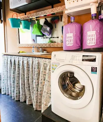 a laundry room with a washer and dryer at Serai House 2BR Cozy Kerobokan Home in Kerobokan