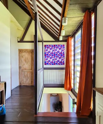 a living room with a staircase in a house at Serai House 2BR Cozy Kerobokan Home in Kerobokan