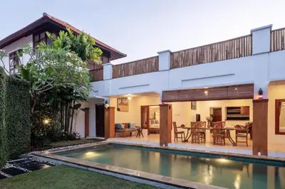 a villa with a swimming pool in front of a house at Genta- Petitenget 2BR villa, walk to beach! in Seminyak