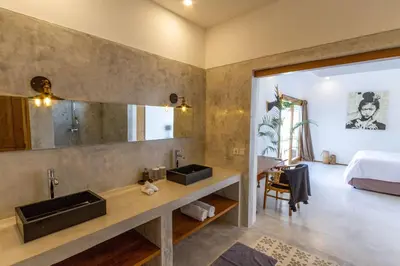 a bathroom with two sinks and a large mirror at Villa Java by DreamAwayBali in Seminyak