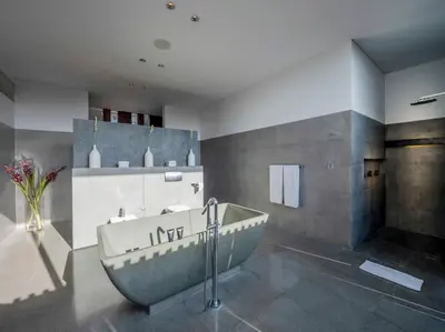 a bathroom with a large tub in a room at Villa Issi in Seminyak