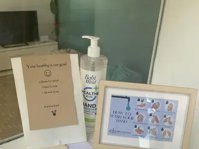 a bottle of hair glue next to a picture and a sign at Villa Issi in Seminyak