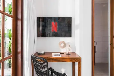 a room with a wooden table with a x on the wall at Saro - Top location near Potato Head, walk everywhere! in Seminyak