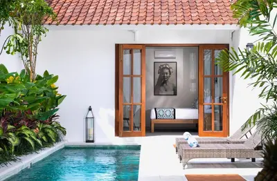 a villa with a swimming pool and a bedroom at Saro - Top location near Potato Head, walk everywhere! in Seminyak