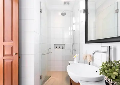 a white bathroom with a sink and a shower at Saro - Top location near Potato Head, walk everywhere! in Seminyak